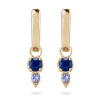 Gold earrings with blue and purple gemstones on a white background