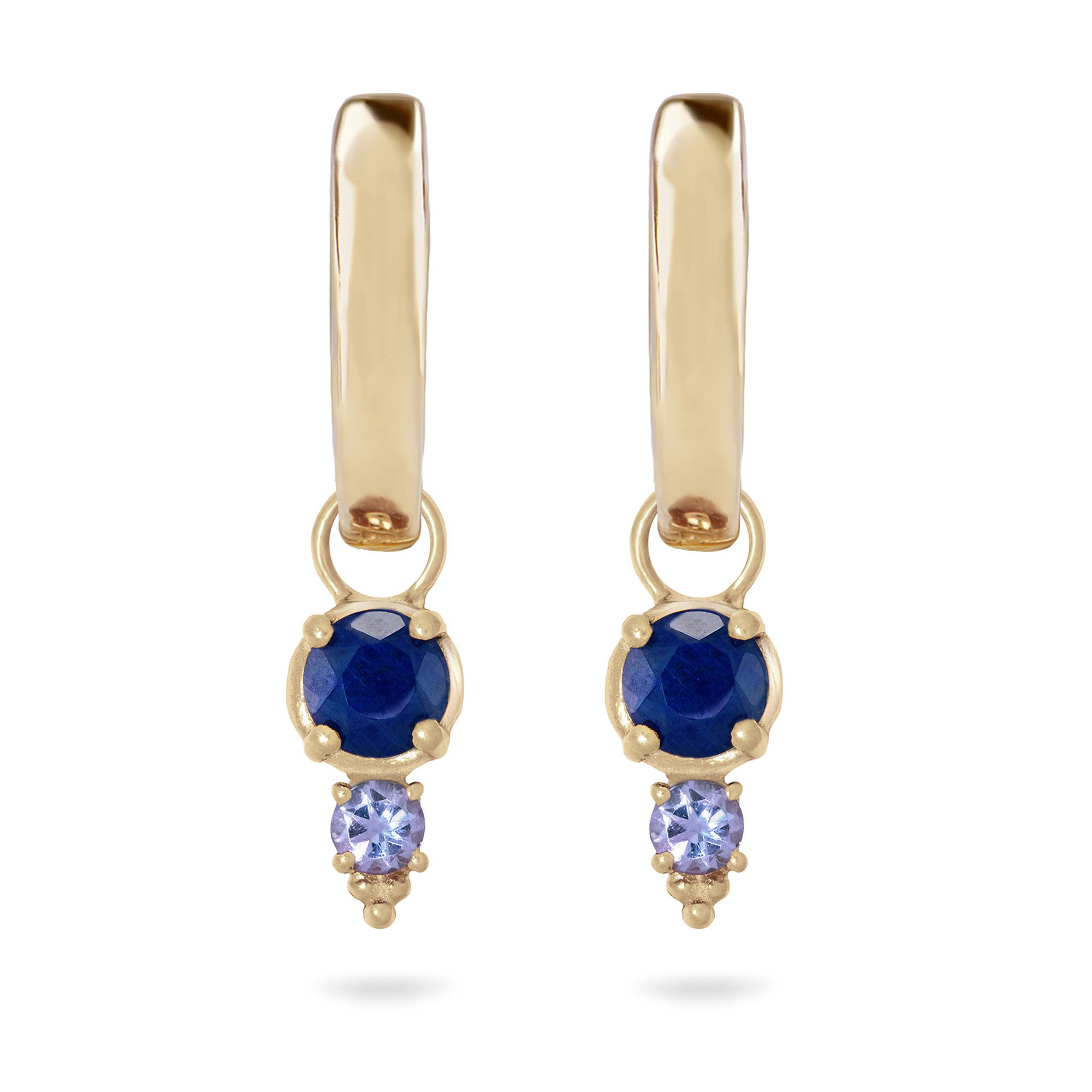 Gold earrings with blue and purple gemstones on a white background