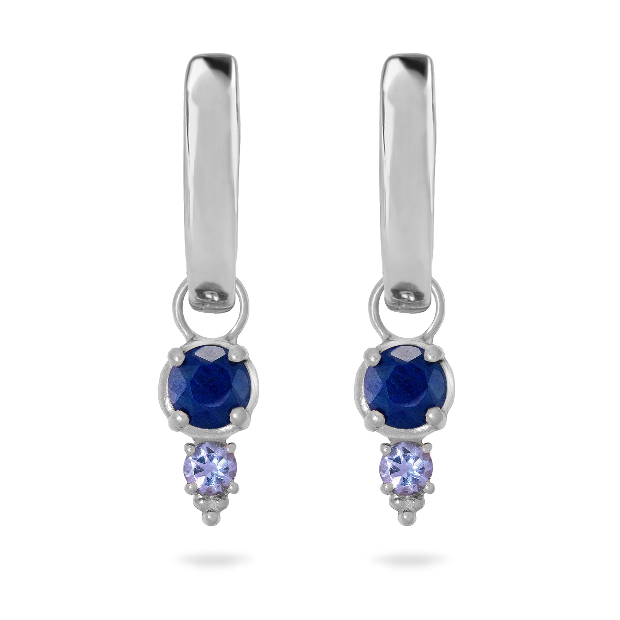 Pair of silver earrings with blue gemstones on a white background