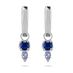 Pair of silver earrings with blue gemstones on a white background