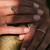 model hands wearing solid gold rings including the Scattered Diamond Band Ring 9k Gold