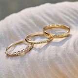 Scattered Diamond Band Ring 9k Gold displayed along with other solid gold bands