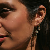 model wearing solid gold earrings including the Snake Flat Back Earring 14k Gold