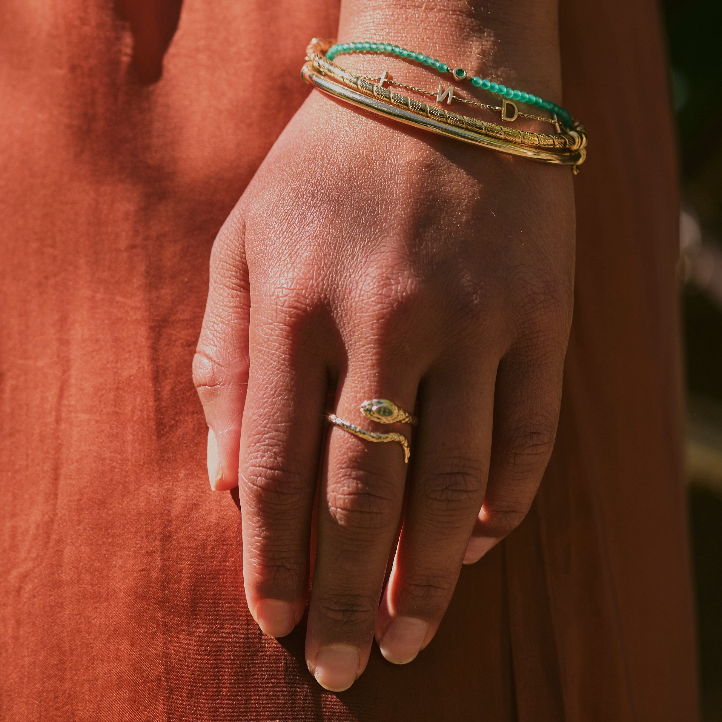 model wearing the Snake Ring 9k Gold and solid gold bracelets