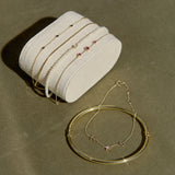 solid gold bracelets on a green background