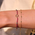 model wearing solid gold bracelets including the Sunburst Silhouette Pink Quartz & Onyx Beaded Bracelet 9k Gold