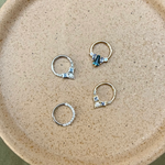 Tanzanite & Diamond Daith Hoop Earring 9k Gold displayed with other solid gold daith earrings