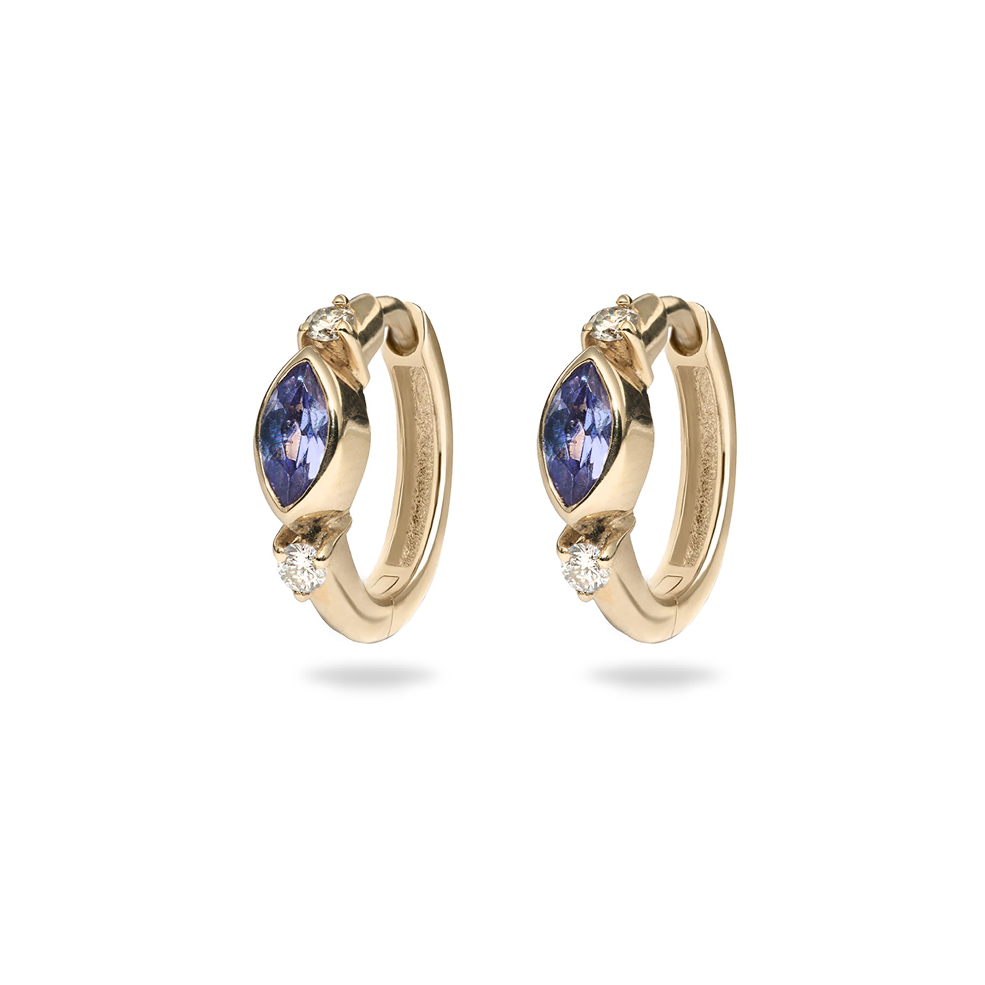 Gold hoop earrings with blue gemstones on a white background