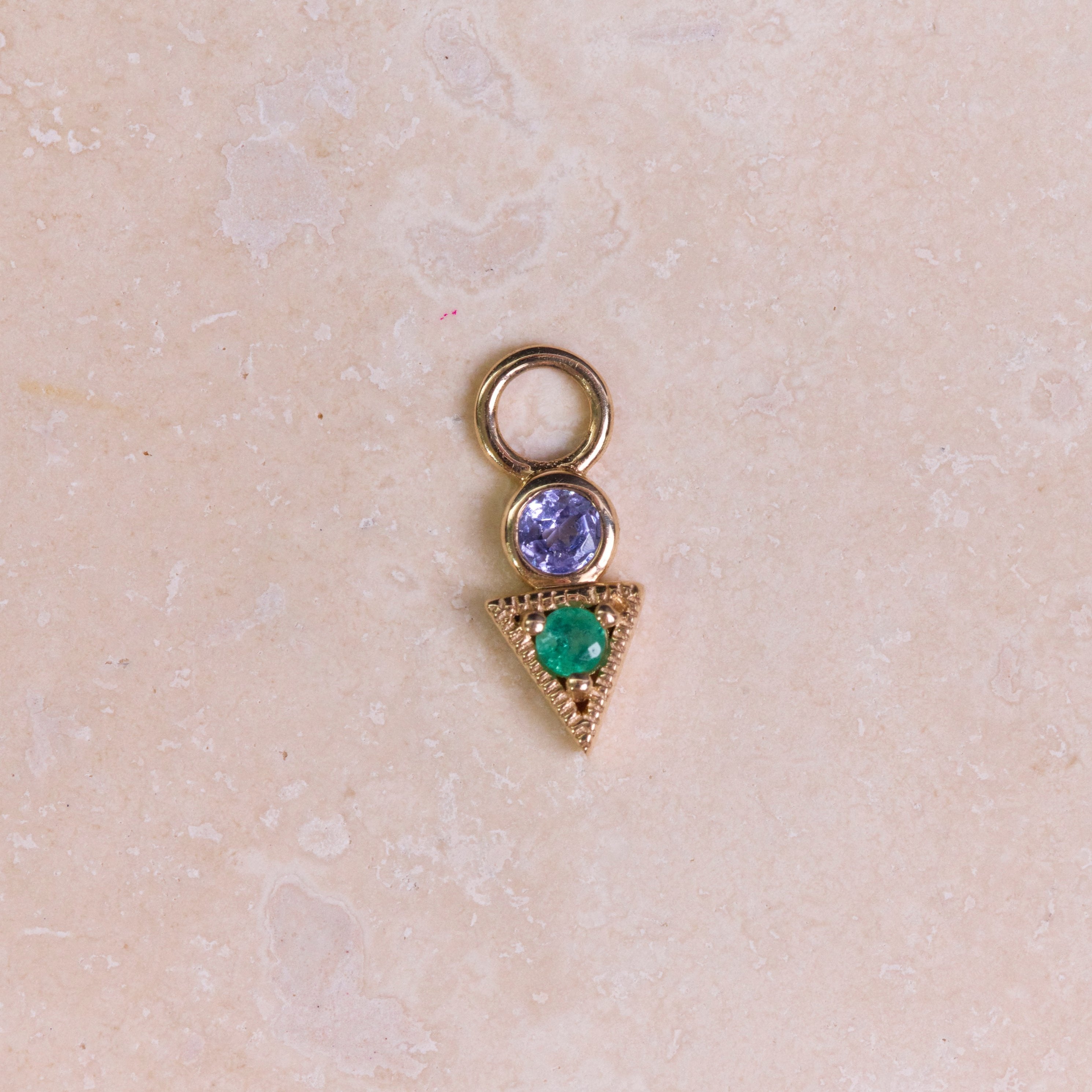 Tanzanite & Emerald Geo Earring Charm 9k Gold on hard surface