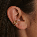 model ear wearing 14k gold vermeil ear cuffs including the Topaz Crossover Ear Cuff 14k Gold Vermeil
