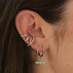 model wearing silver ear stack including the Topaz Crossover Ear Cuff Sterling Silver