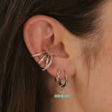 model wearing silver ear stack including the Topaz Crossover Ear Cuff Sterling Silver