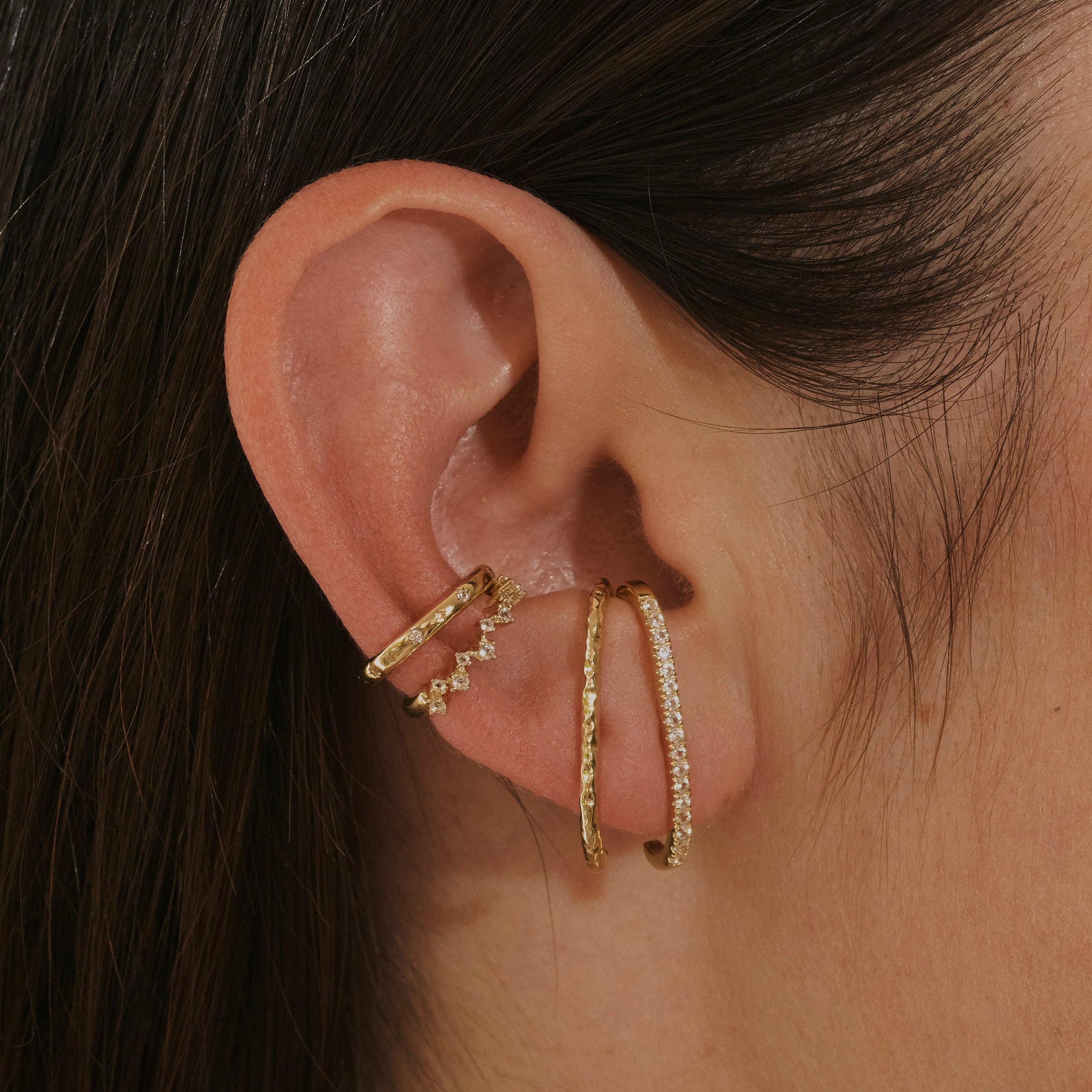 model wearing 14k gold vermeil ear stack including the Topaz Scattered Ear Cuff in 14k Gold Vermeil and suspender earrings