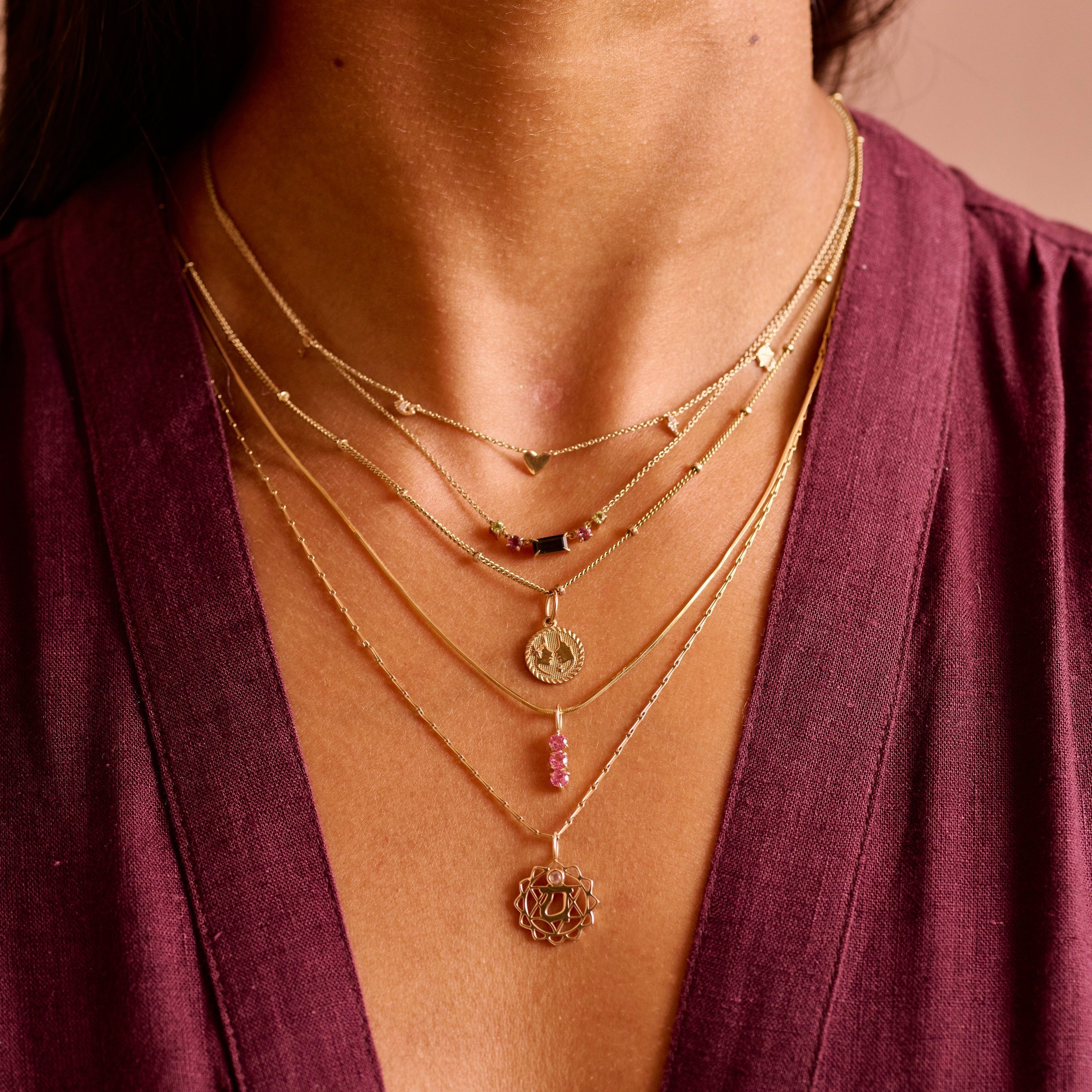 close up of solid gold layered necklaces including the Watermelon Tourmaline Necklace 9k Gold