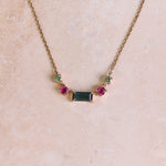 Watermelon Tourmaline Necklace 9k Gold on hard surface