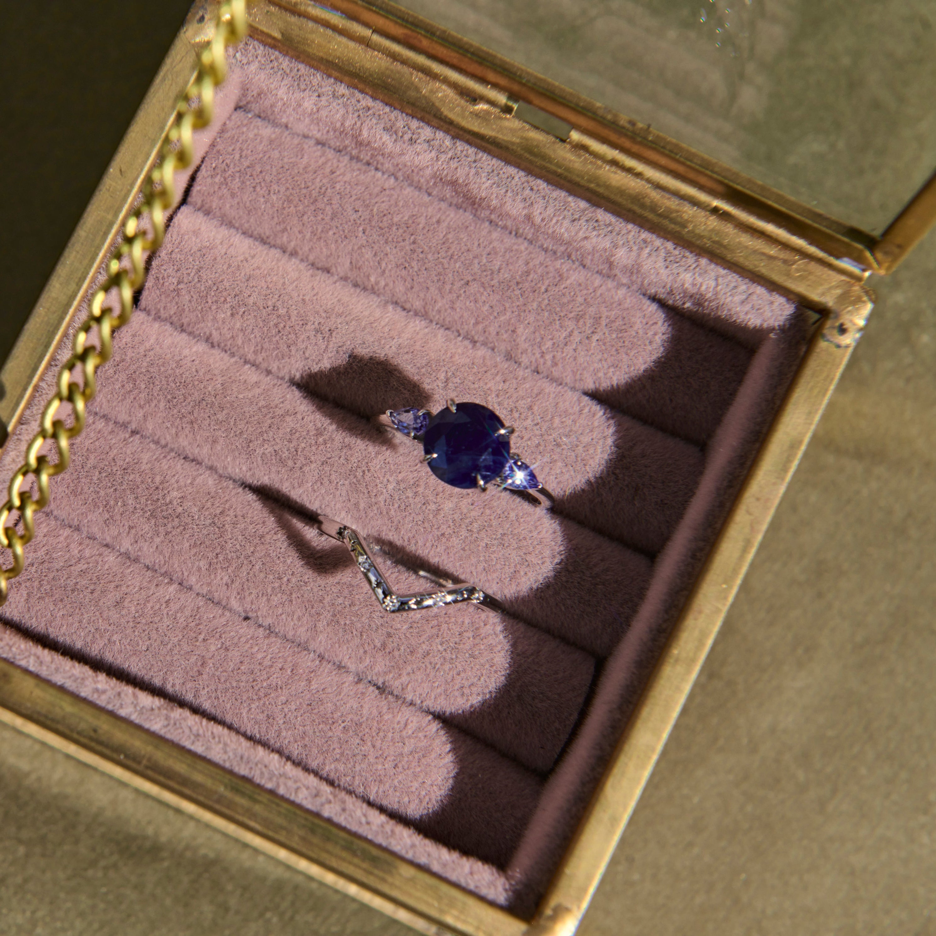 Ring with a purple gemstone in a jewelry box