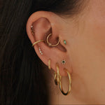 close up of ear stack in gold including the White Sapphire Celestial Ear Cuff 14k Gold Vermeil