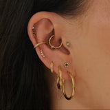 close up of ear stack in gold including the White Sapphire Celestial Ear Cuff 14k Gold Vermeil