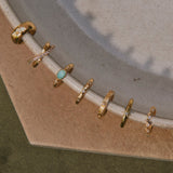 14k gold vermeil ear cuffs displayed on porcelain dish including the White Sapphire Celestial Ear Cuff 14k Gold Vermeil