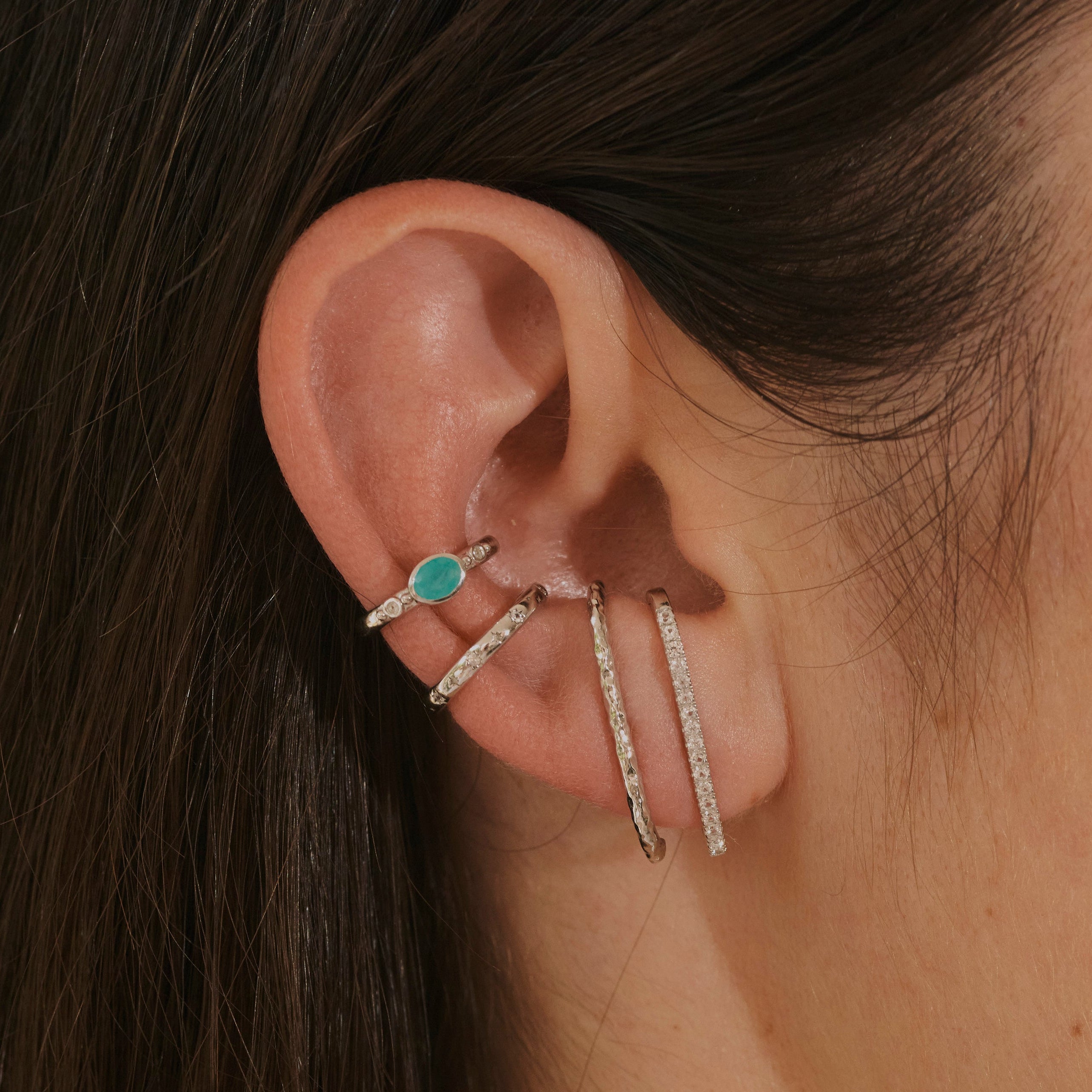 close up of ear stack in silver including the White Sapphire Celestial Ear Cuff Sterling Silver