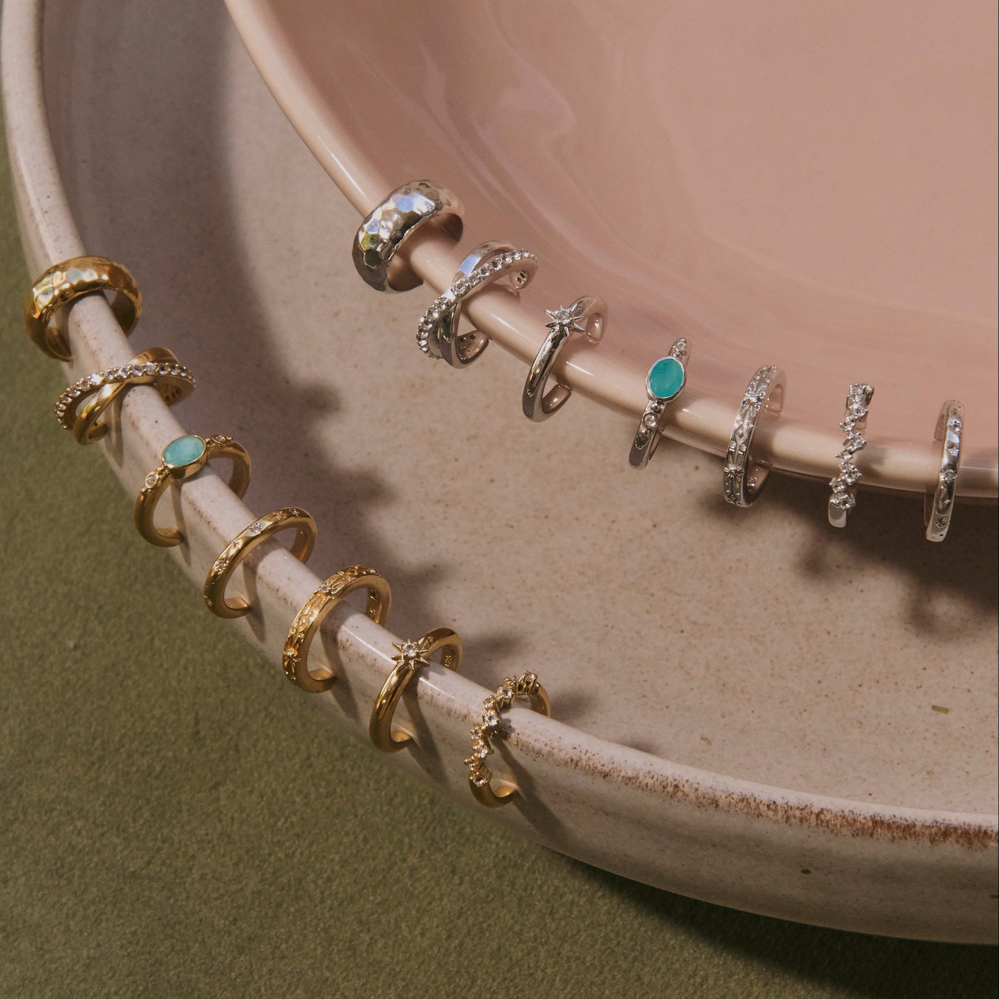 14k gold vermeil and sterling silver ear cuffs displayed on porcelain dishes including the White Sapphire Celestial Ear Cuff 14k Gold Vermeil