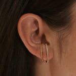model wearing the White Sapphire Pave Suspender Earring 14k Gold Vermeil and  hammered suspender earring