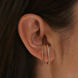 model wearing the White Sapphire Pave Suspender Earring 14k Gold Vermeil and  hammered suspender earring
