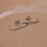 close up of the White Sapphire Pave Suspender Earring Sterling Silver and hammered suspender earring