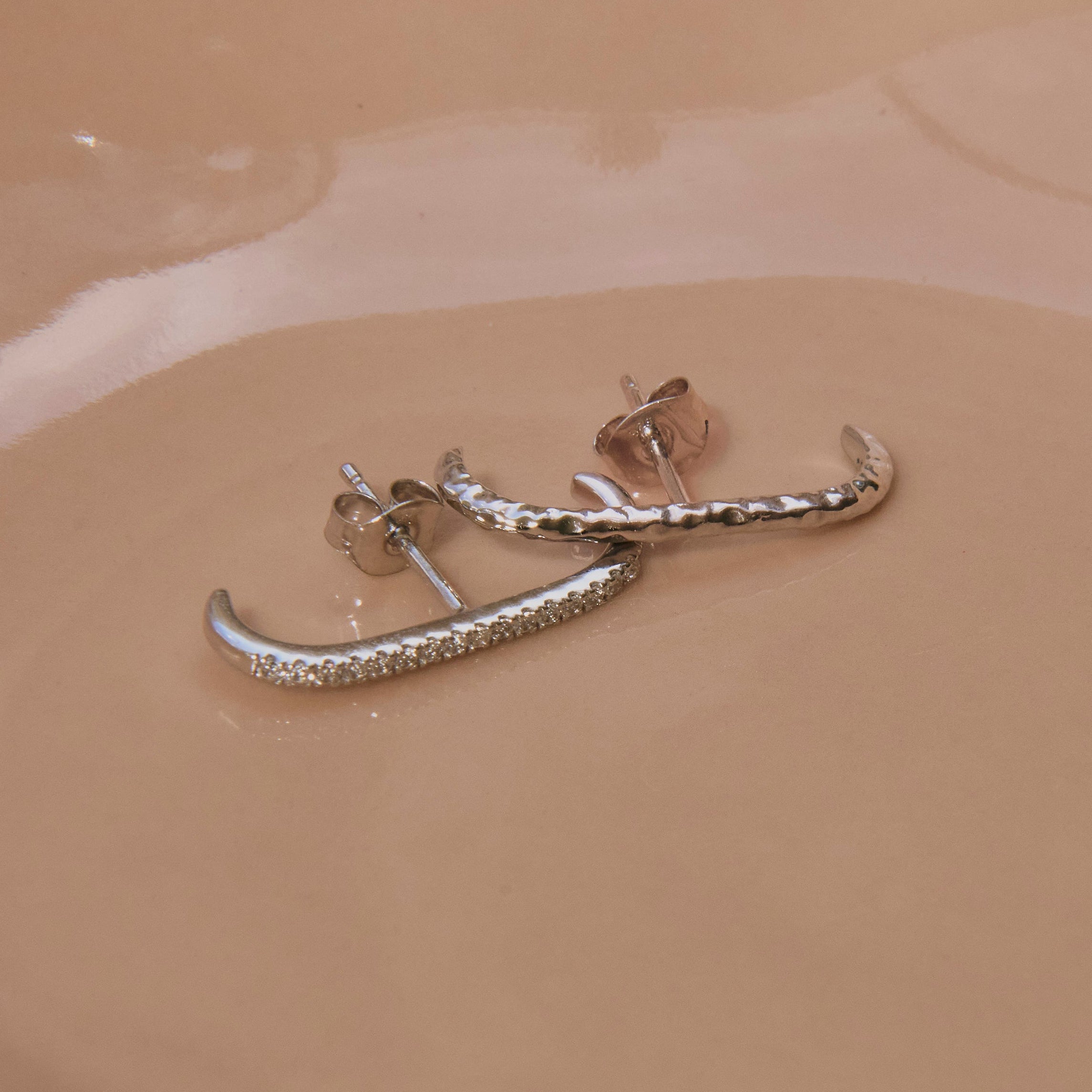close up of the White Sapphire Pave Suspender Earring Sterling Silver and hammered suspender earring