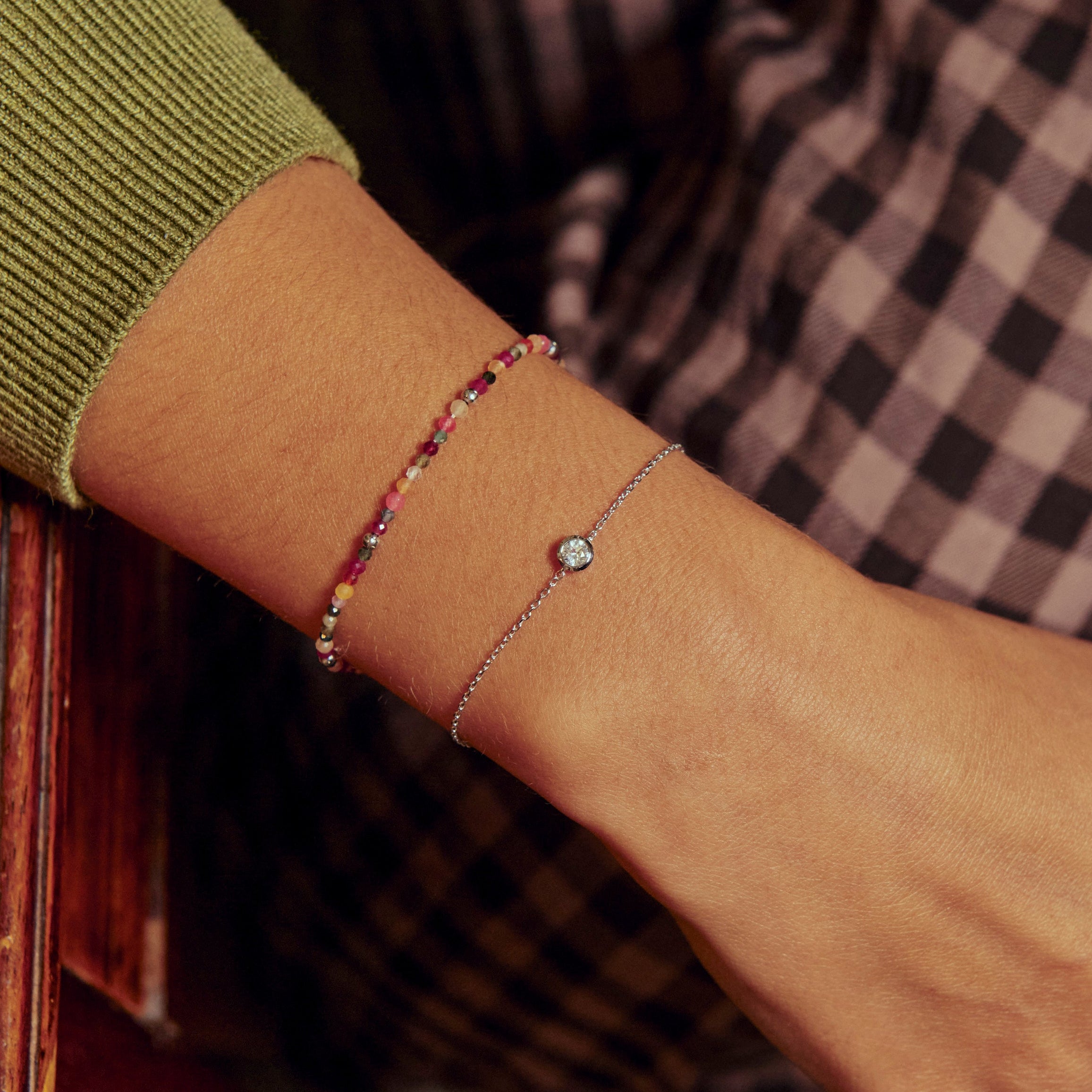 model wearing White Sapphire Solitaire Bracelet Sterling Silver along with beaded bracelet