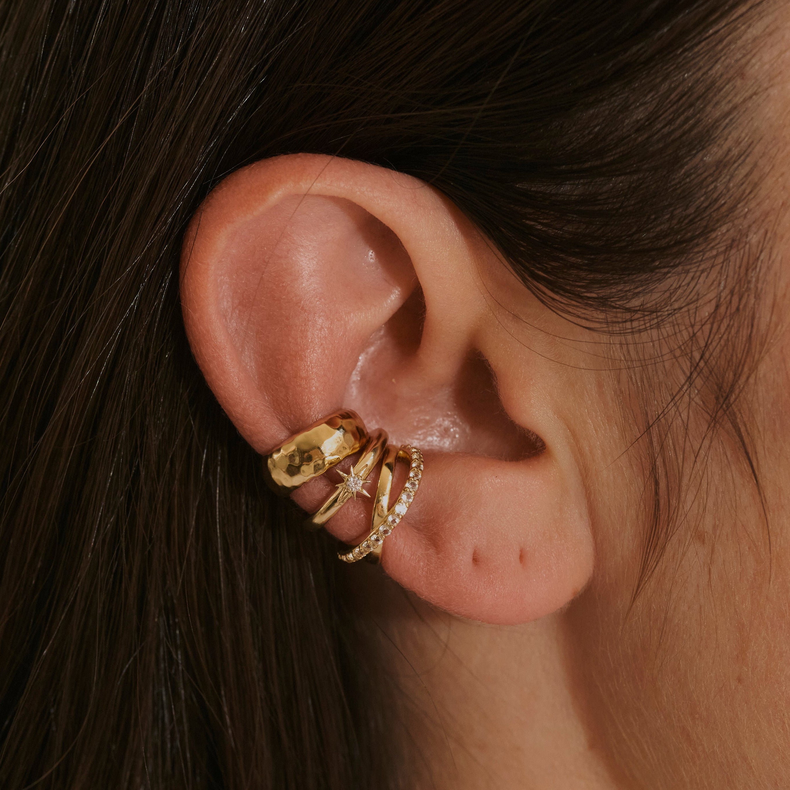 model wearing ear cuffs including the White Sapphire Star Ear Cuff 14k Gold Vermeil
