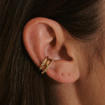 model wearing the White Sapphire Star Ear Cuff 14k Gold Vermeil and the topaz crossover ear cuff