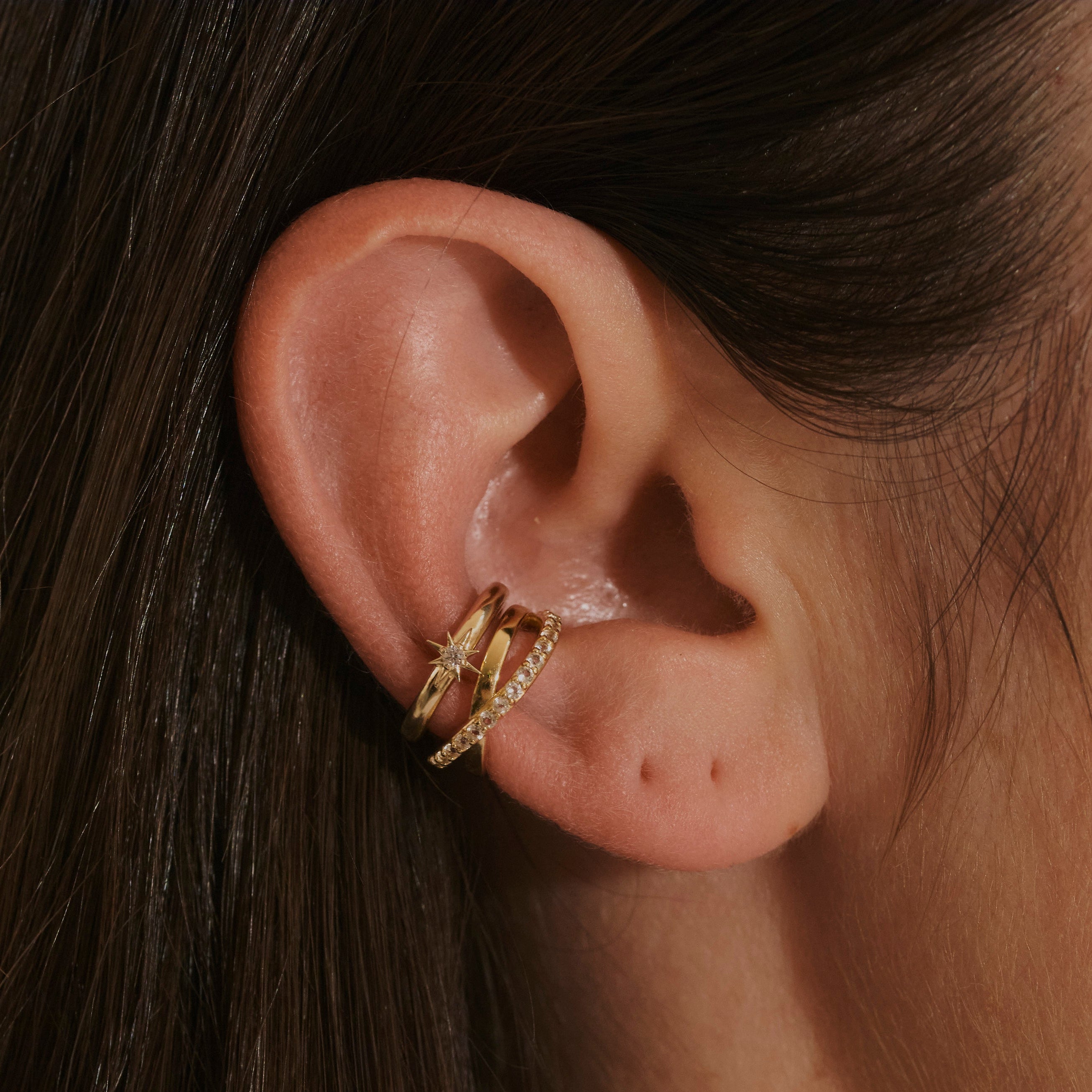 model wearing the White Sapphire Star Ear Cuff 14k Gold Vermeil and the topaz crossover ear cuff