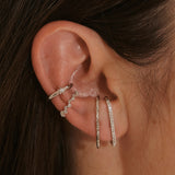 model wearing sterling silver suspender earrings and ear cuffs including the White Sapphire Star Ear Cuff Sterling Silver