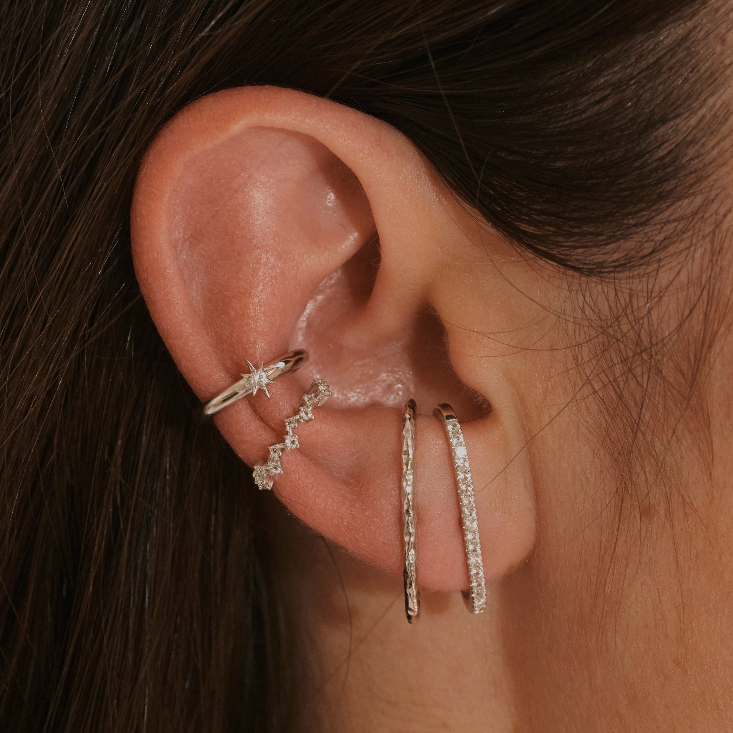 model wearing sterling silver suspender earrings and ear cuffs including the White Sapphire Star Ear Cuff Sterling Silver