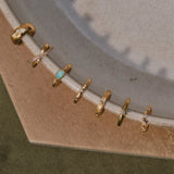 14k gold vermeil ear cuffs displayed on porcelain dish edge including the White Sapphire Starburst Ear Cuff 14k Gold Vermeil