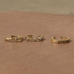 White Sapphire Starburst Ear Cuff 14k Gold Vermeil displayed on stone surface along with other 14k gold vermeil ear cuffs