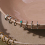sterling silver ear cuffs displayed on porcelain dish including the White Sapphire Starburst Ear Cuff Sterling Silver
