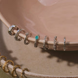 sterling silver ear cuffs displayed on porcelain dish including the White Sapphire Starburst Ear Cuff Sterling Silver

