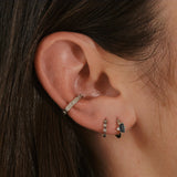 close up of ear stack in silver including the White Sapphire Starburst Ear Cuff Sterling Silver
