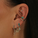 model wearing sterling silver ear stack including the White Sapphire Starburst Ear Cuff Sterling Silver