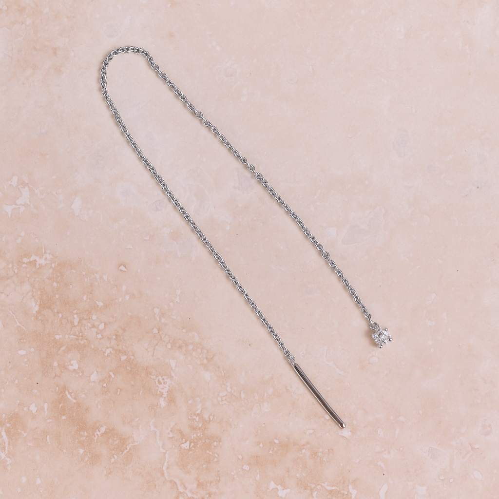 diamond white gold earring threader on stone background