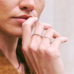 Close-up of a person wearing a ring with a blurred background