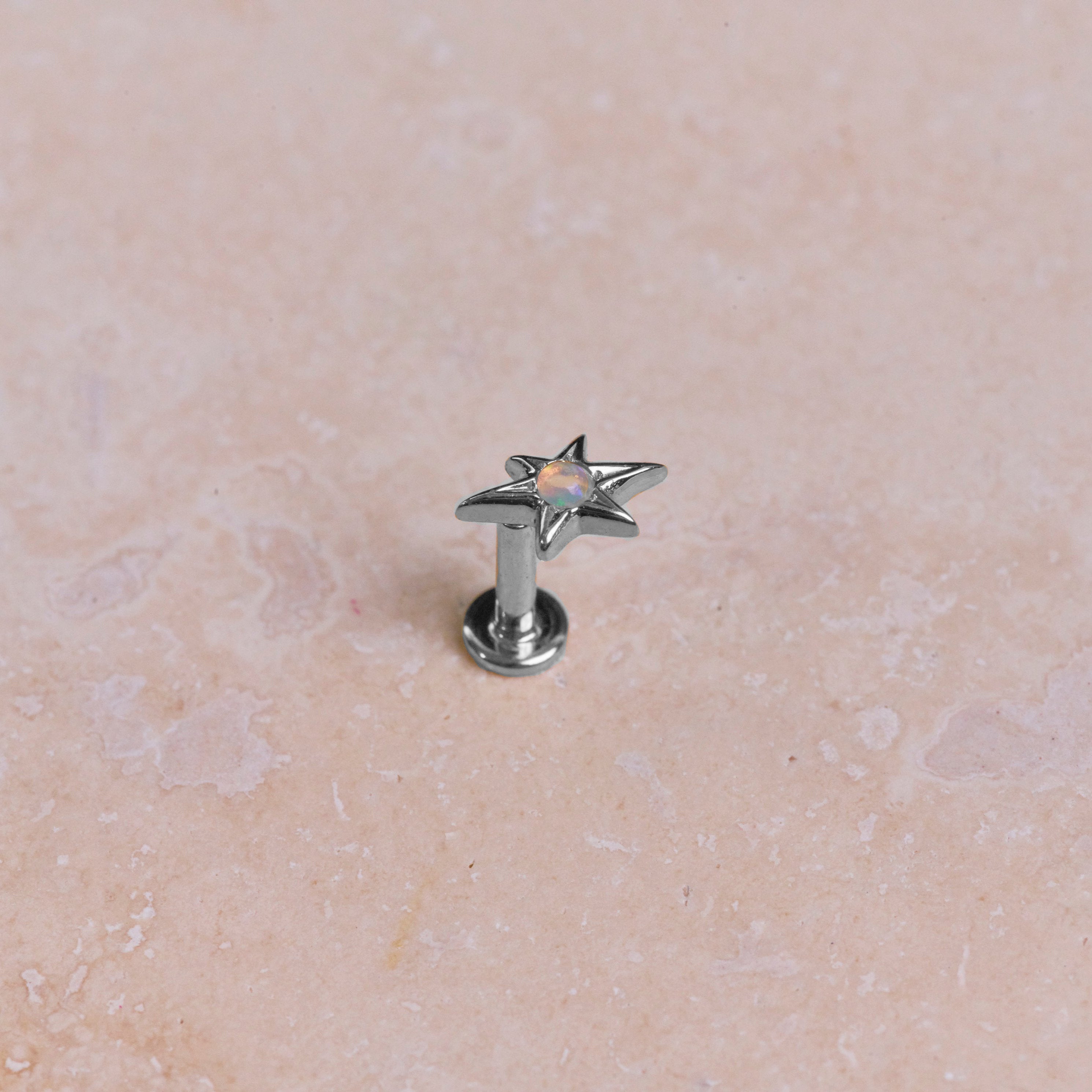 White gold earring on stone
