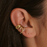 close up of model ear stacking 14k gold vermeil ear cuffs including the Wide Hammered Ear Cuff 14k Gold Vermeil