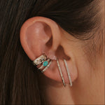 close up of model ear wearing silver suspender earrings and ear cuffs including the Wide Hammered Ear Cuff Sterling Silver