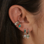 model wearing silver earrings and ear cuffs including the Wide Hammered Ear Cuff Sterling Silver