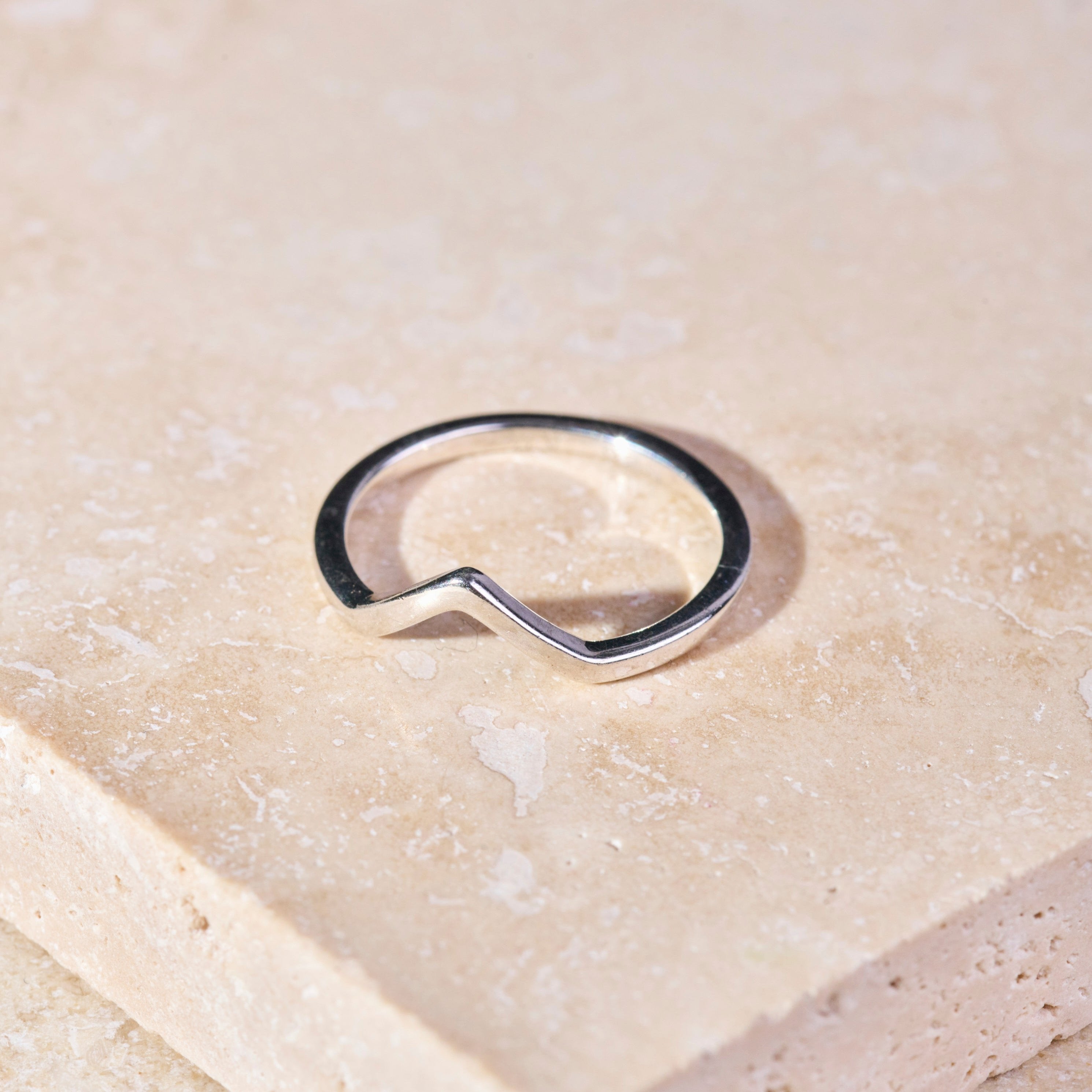 close up of the Wishbone Ring Sterling Silver on marble surface