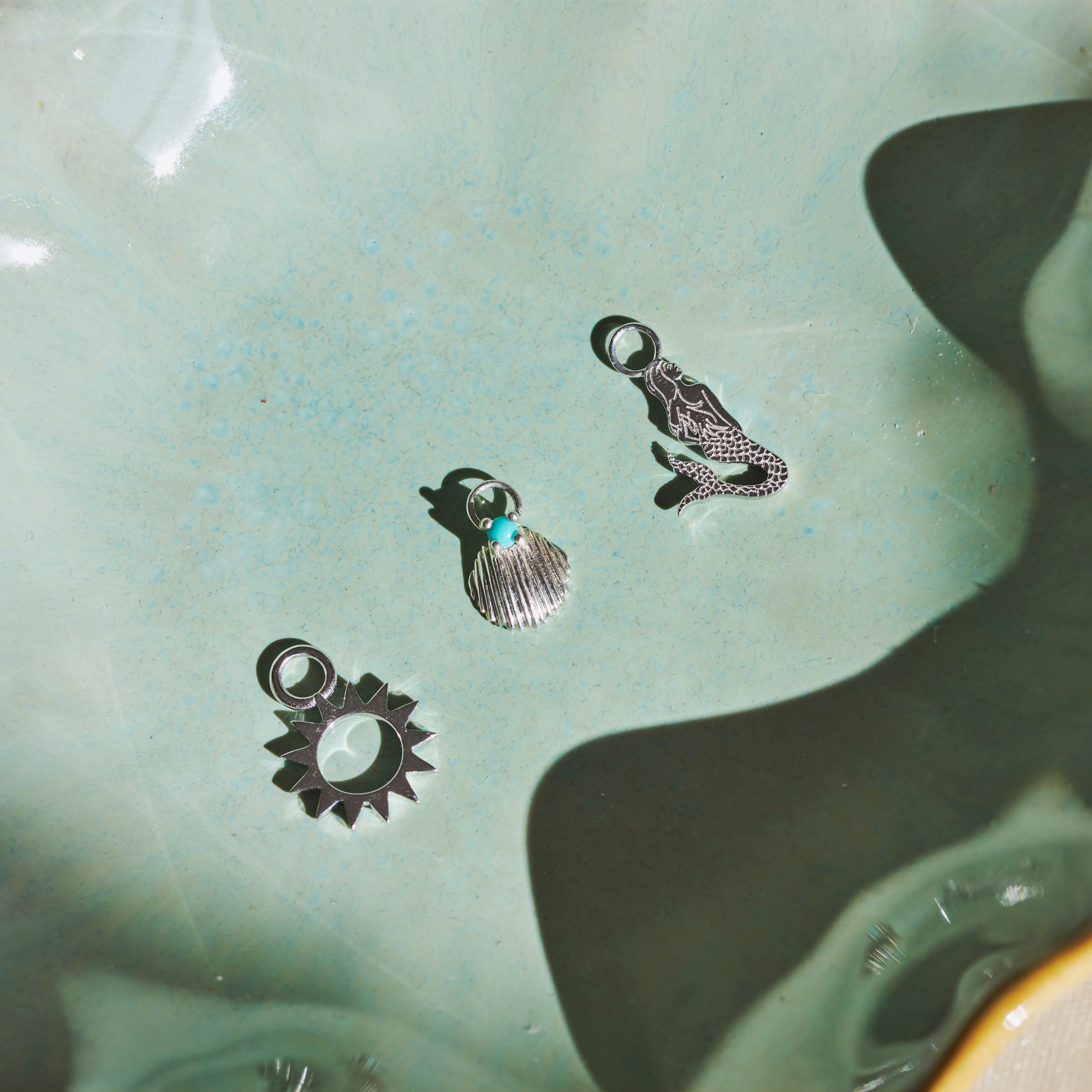 mermaid charm on green background
