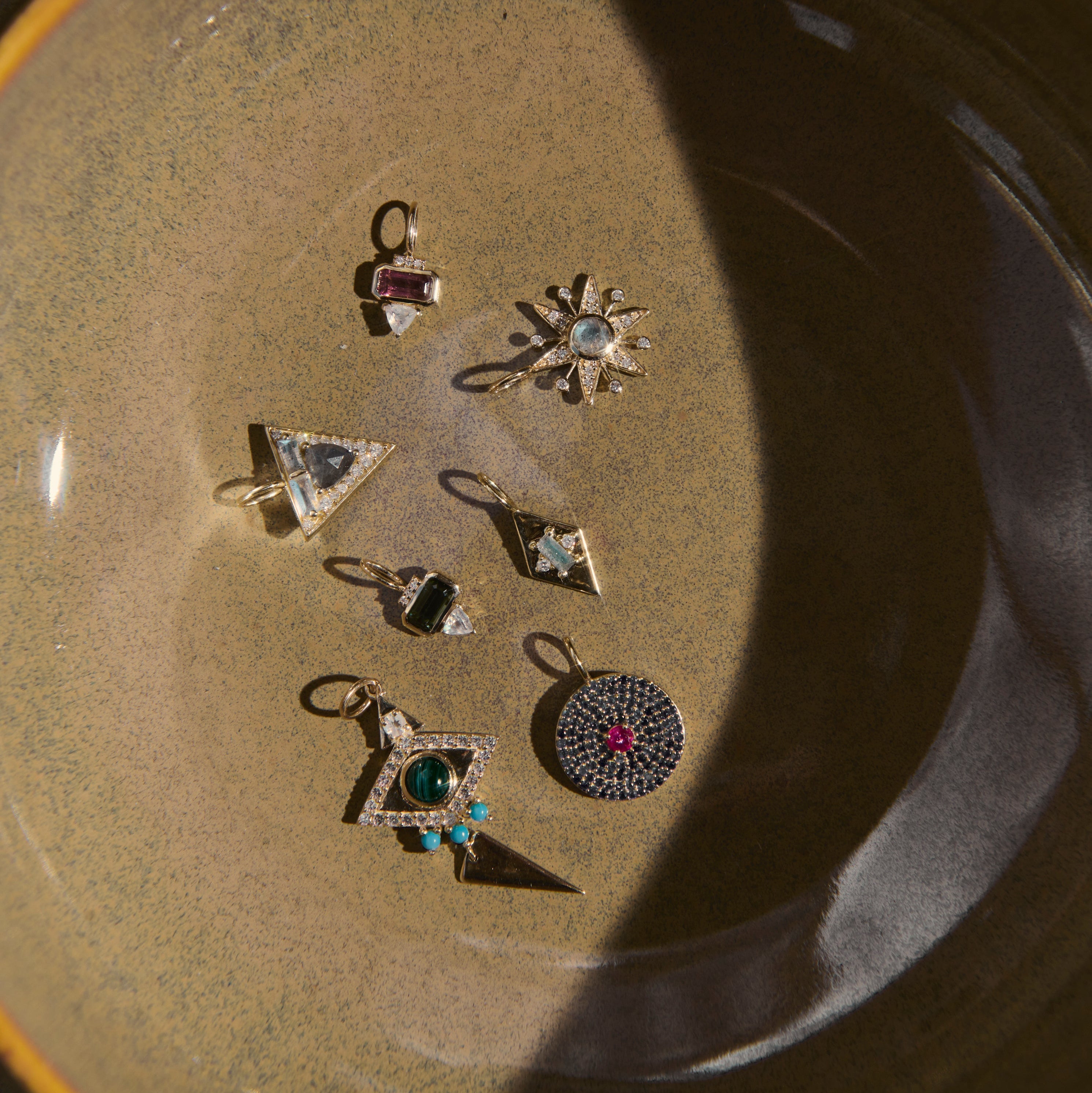 Set of small silver jewelry pieces on a textured surface
